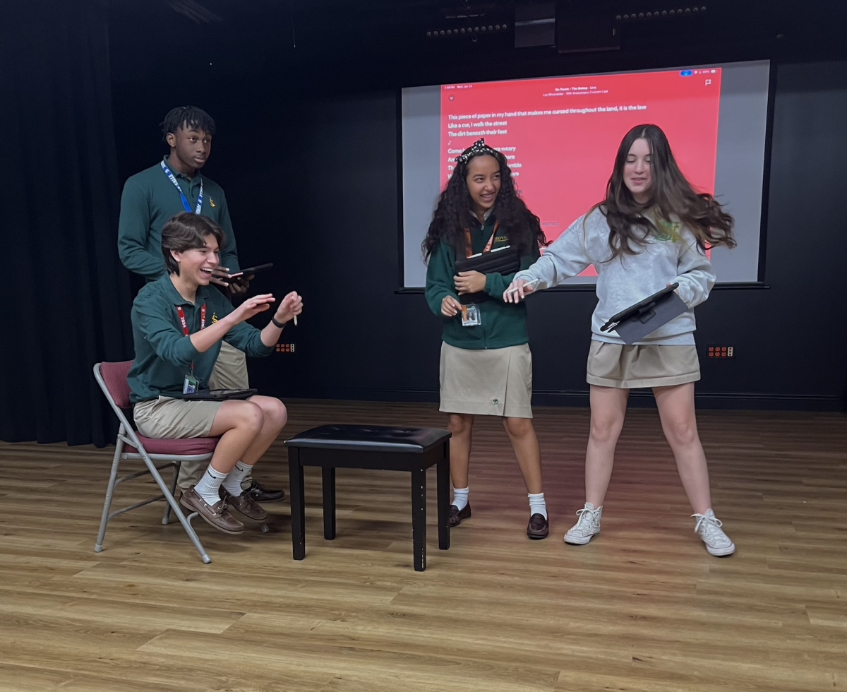 From left to right: Junior Rashad Lee (playing the Bishop in this scene), senior Sebastian Pacheco (playing Jean Valjean), sophomore Clara Custodio, and Amy Pichardo (both playing nuns in this particular scene) going over blocking for one of the first scenes in the show. 
